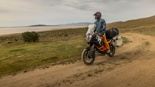 Man riding his motorcycle along the scenic seaside, taking in the outdoor beauty while dressed in his Whiskey Denim Adventure Fit - 6th Gen jeans.