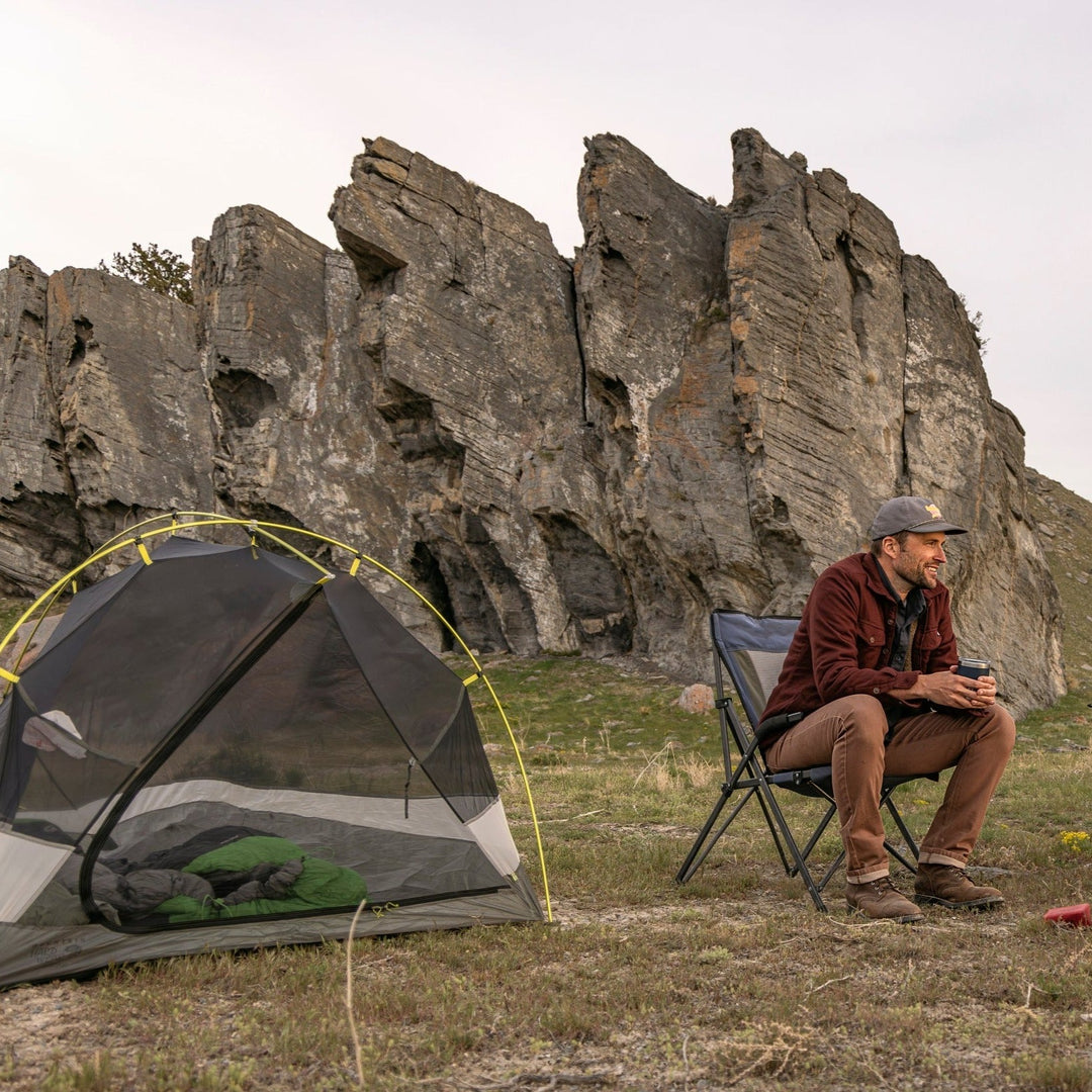 Two friends enjoying outdoor camping, both wearing Tobacco Brown Denim - Slim Fit - 6th Gen Bulletprufe Jeans.
