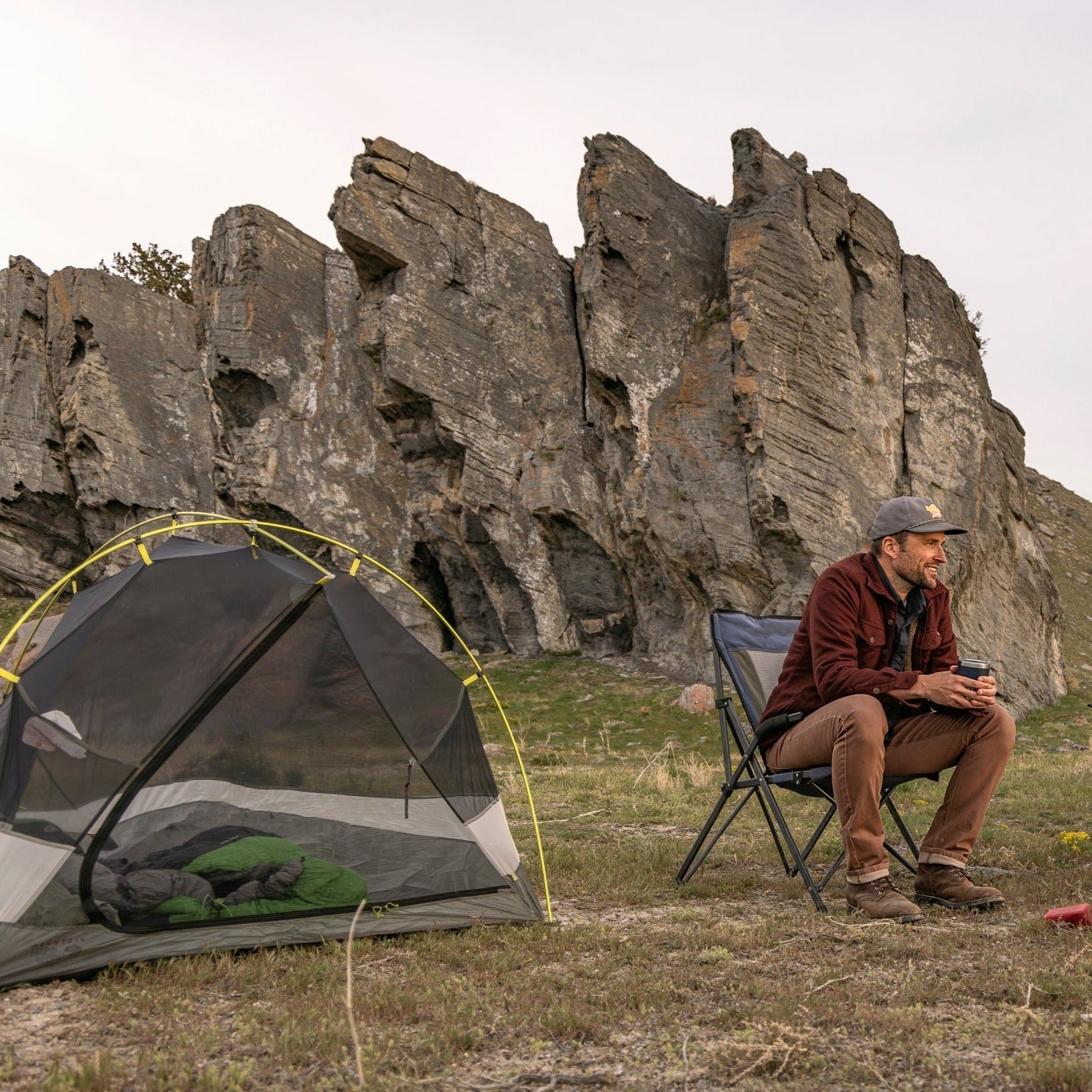 Two friends enjoying outdoor camping, both wearing Tobacco Brown Denim - Slim Fit - 6th Gen Bulletprufe Jeans.