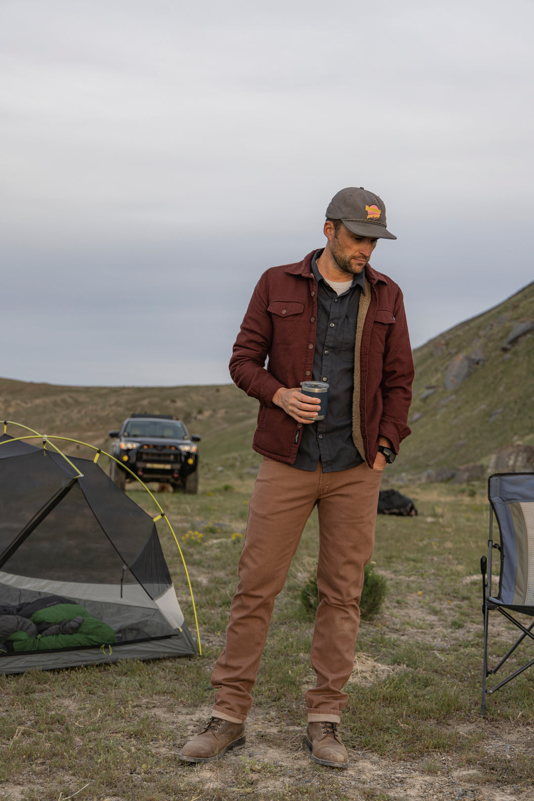 Man wearing Tobacco Brown Denim - Slim Fit - 6th Gen Bulletprufe Jeans, savoring the outdoor scenery