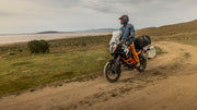 Man riding his motorcycle along the scenic seaside, taking in the outdoor beauty while dressed in his Whiskey Denim Adventure Fit - 4th Gen jeans.