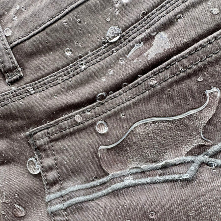 Slate Grey Custom Waxed Tin-Cloth Bulletproofs showcasing waterproof capabilities with water droplet bead on the fabric surface.